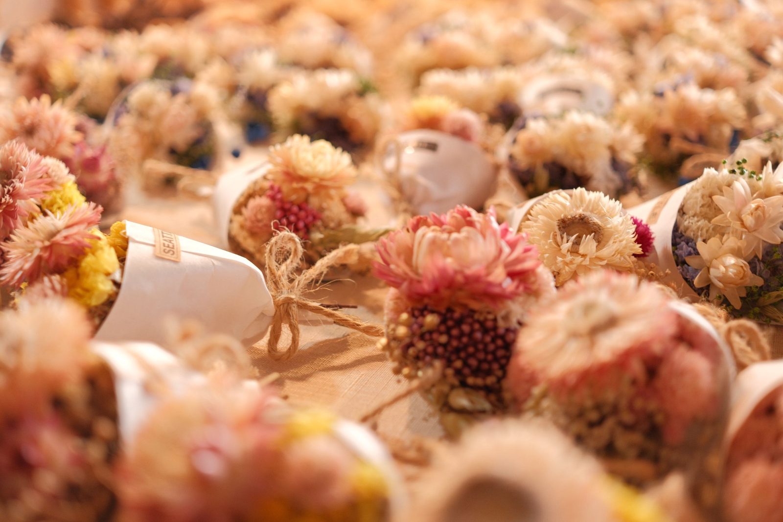 Rows of little dried-flower bouquets tied with twine bows