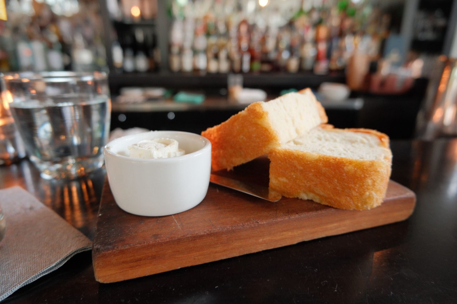 Slices of brioche with whipped butter on a wooden board