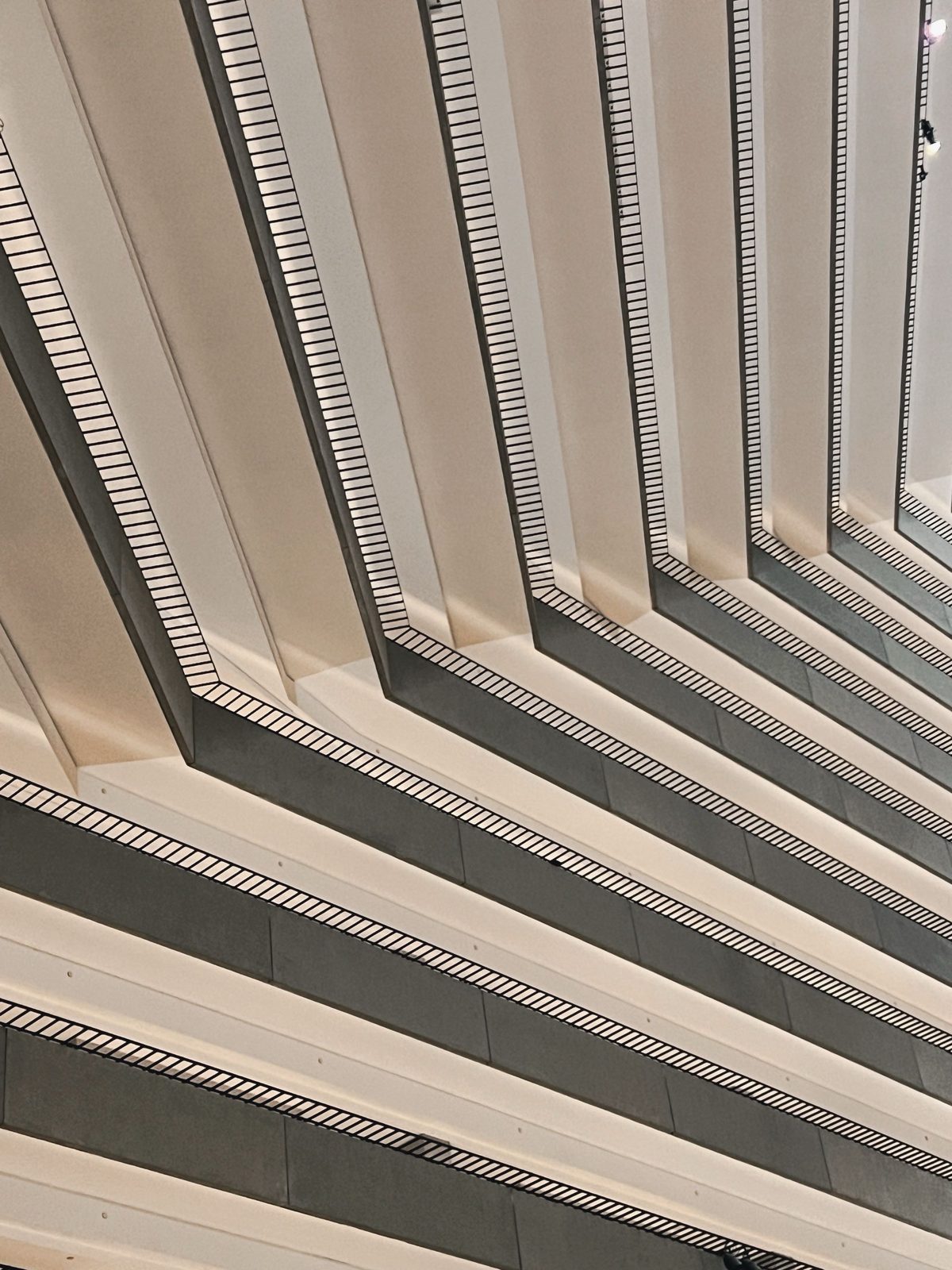 The stacked balconies of an atrium forming a sharp diagonal