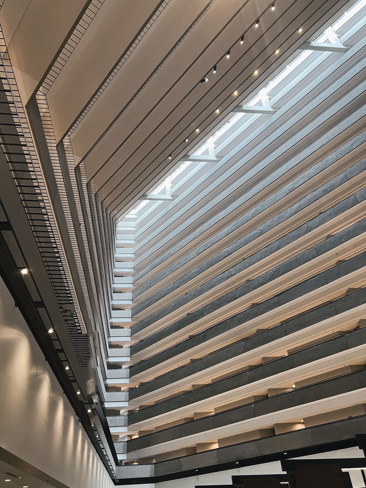 A hotel atrium ceiling opening to a skylight above tiered floors