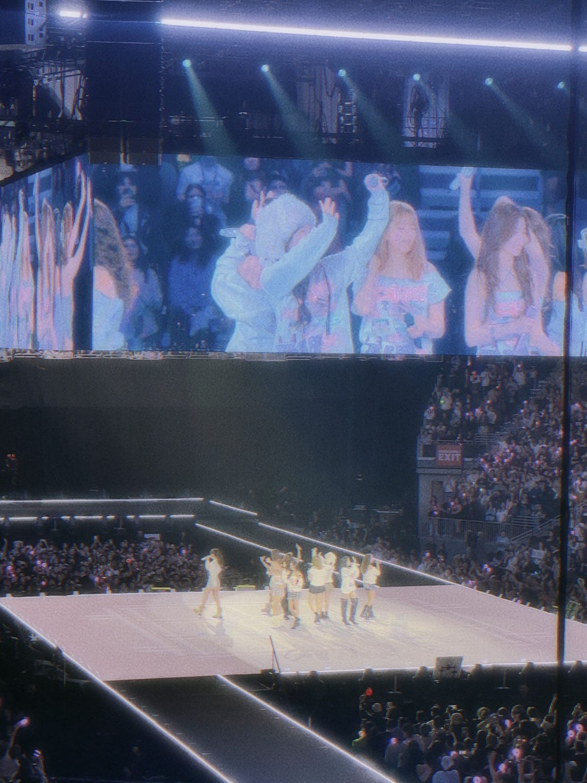 A concert stage with the performer mirrored on giant screens