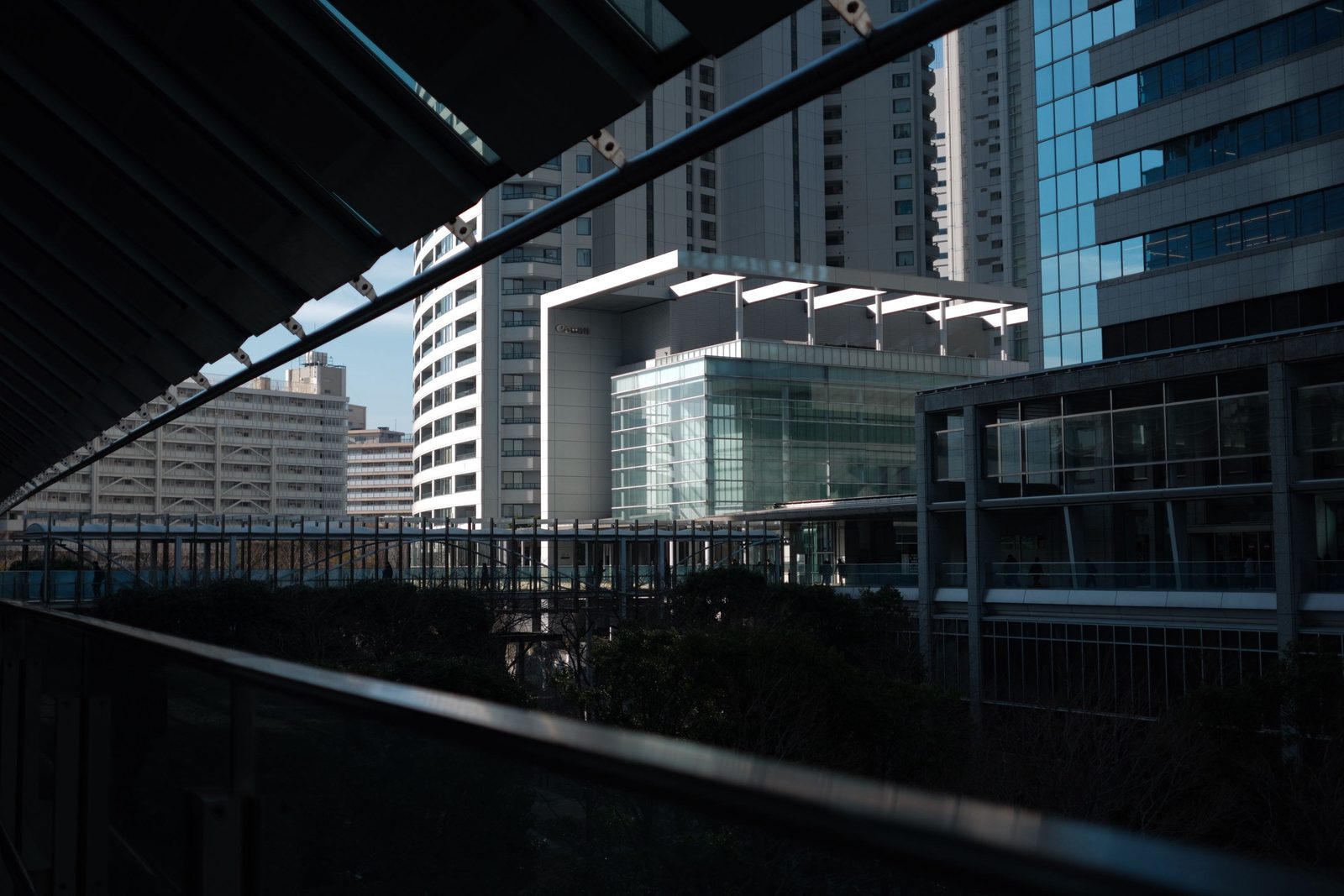 Tokyo office towers framed by a glass walkway