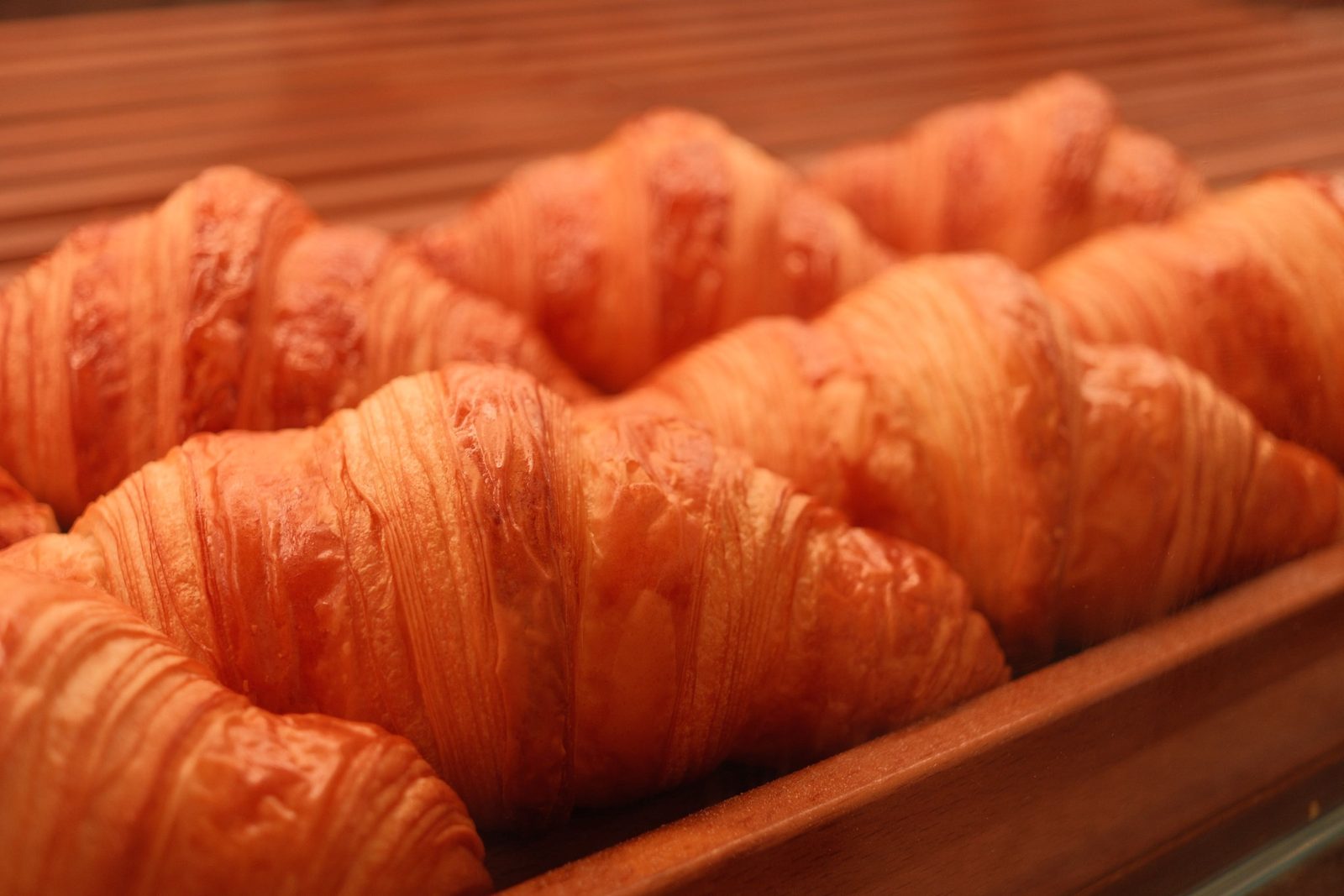 A tray of freshly baked, golden croissants