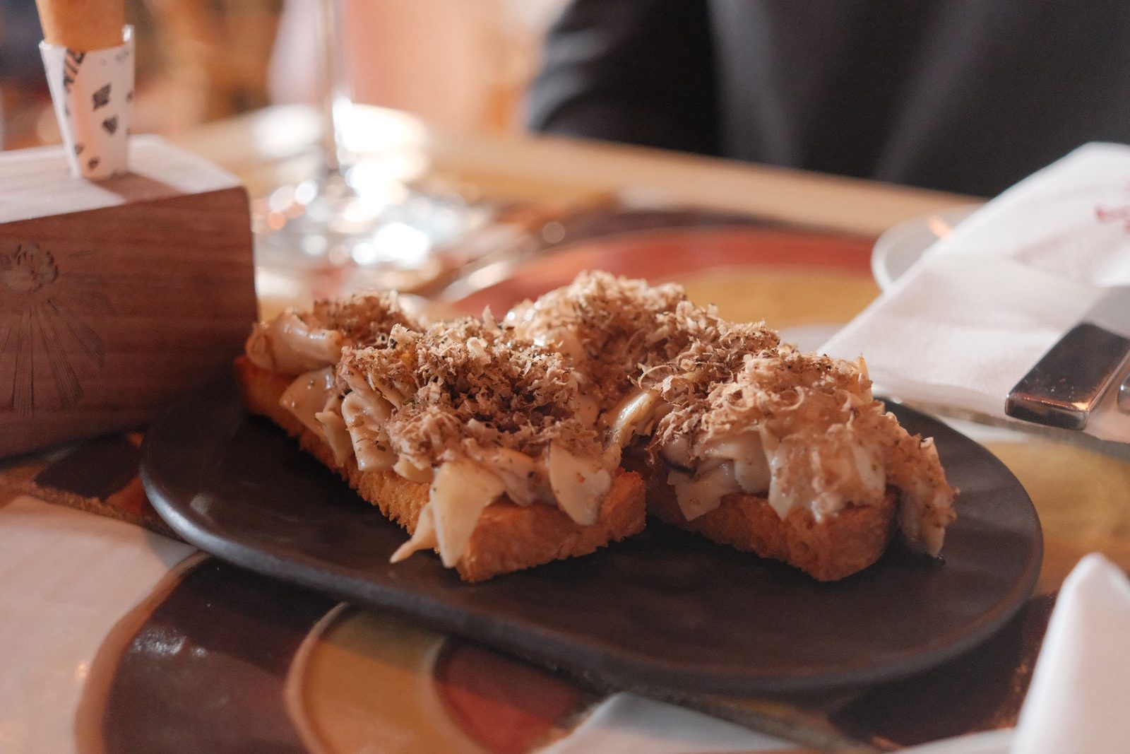 Mushroom toast finished with a flurry of shaved truffle