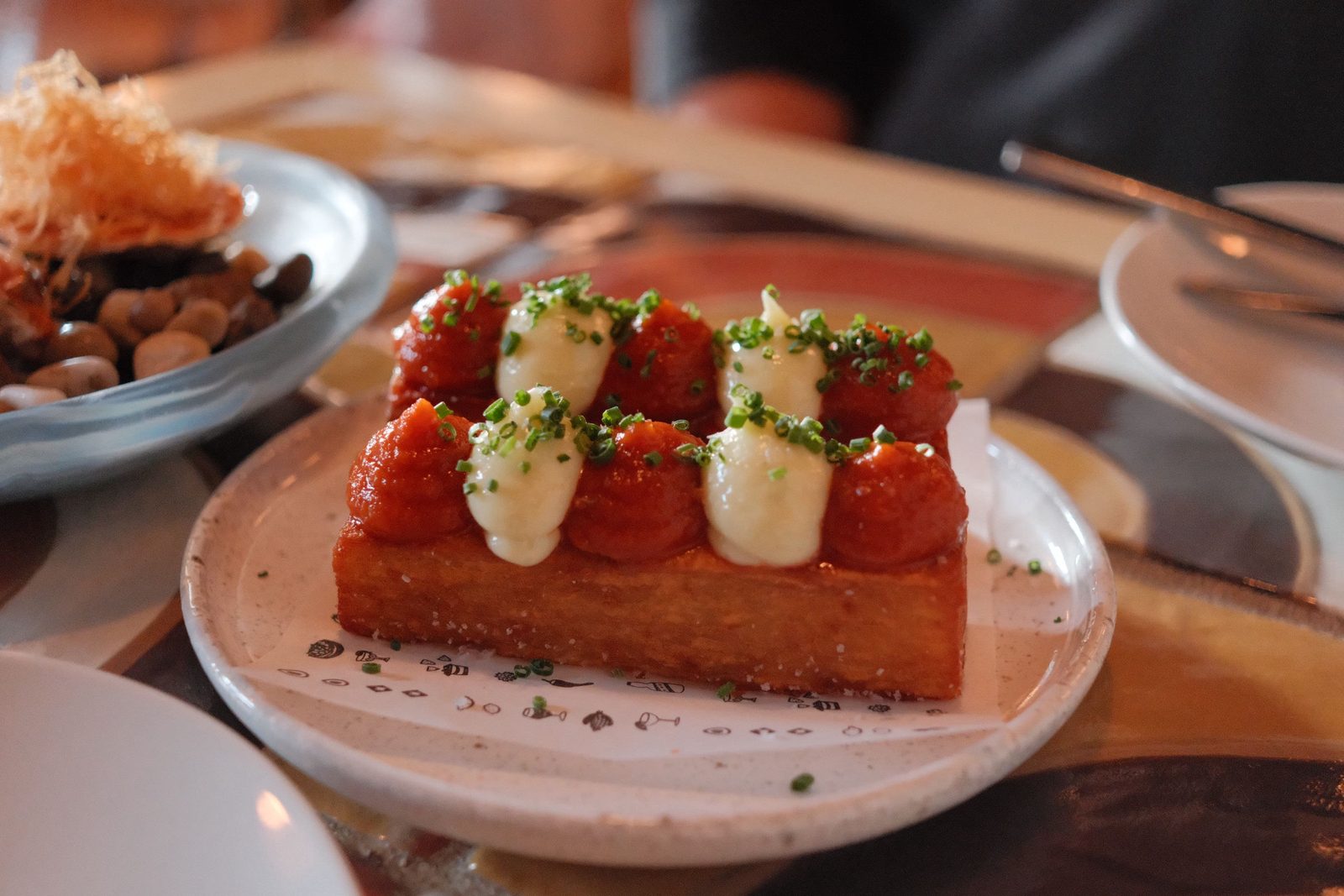 Caramelized toast crowned with strawberries and piped cream