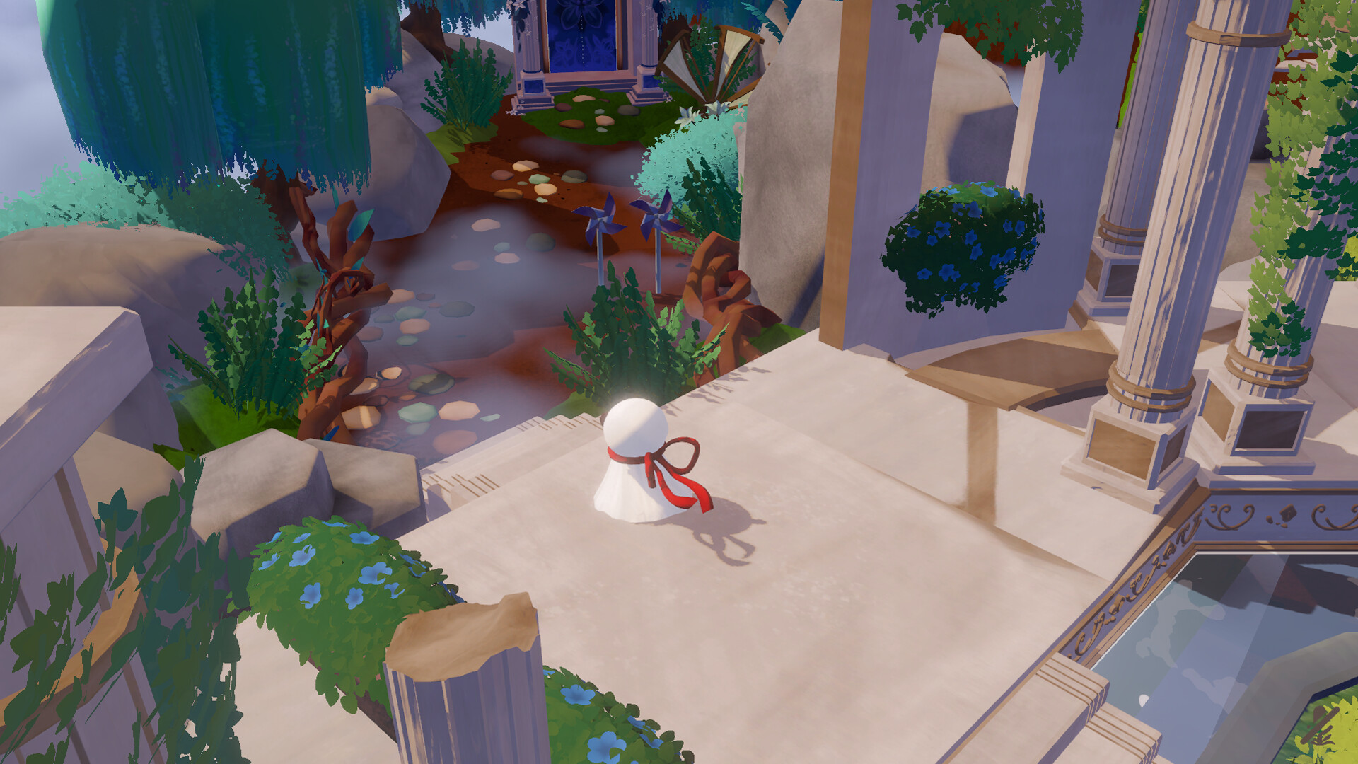 The Wisp on a stone patio overlooking a flowering garden and temple ruins